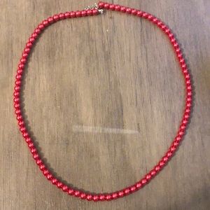 Long, red pearl necklace